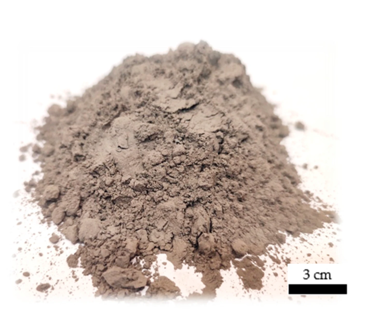 Fine basalt powder with small agglomerates, photographed beside a 3 cm scale
